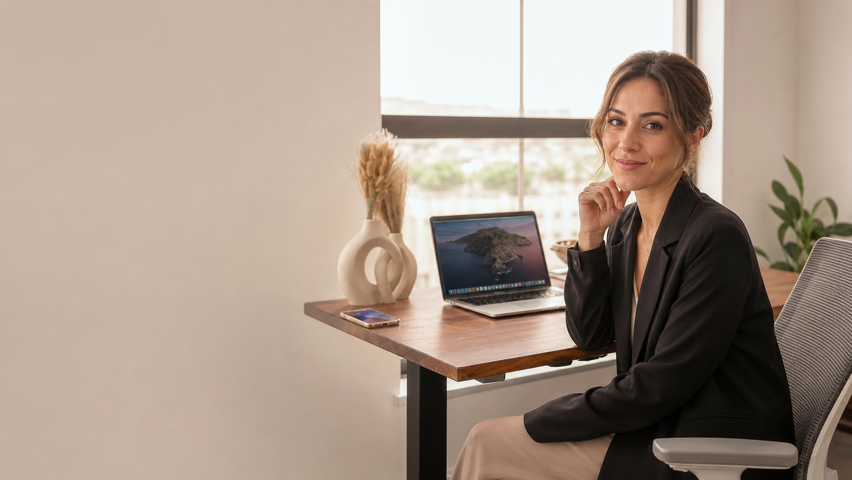 Professional working by a desk in a bright office