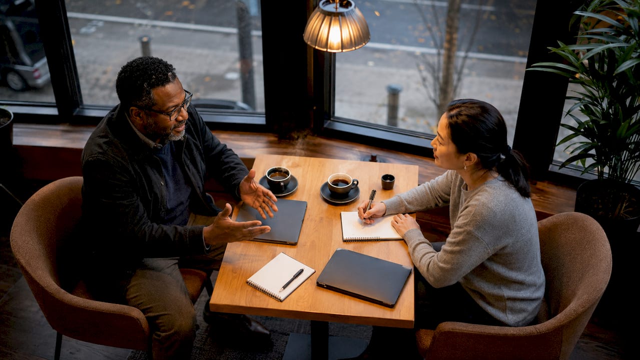 Manager and employee in performance review meeting conversation